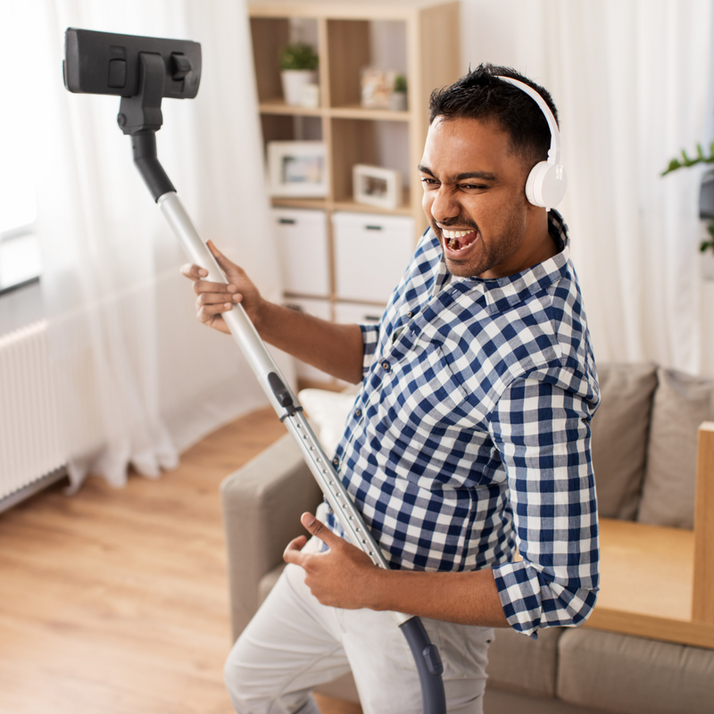 household and cleaning concept - indian man in headphones with vacuum cleaner having fun at home

base Image AdobeStock_269379813